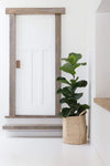 Natural Jute Laundry Basket with plant in entryway