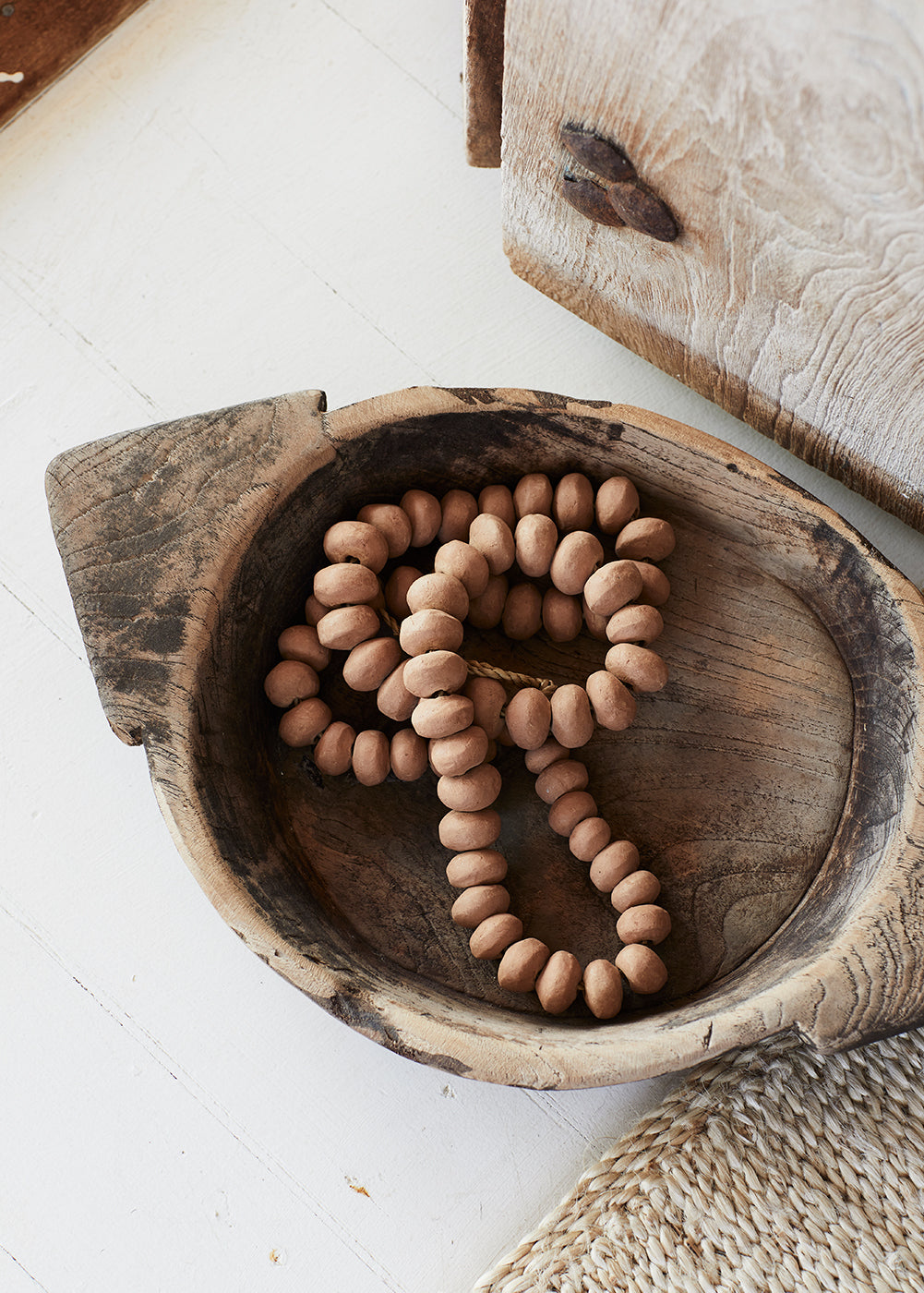 Natural home decor with clay beads in a wooden bowl