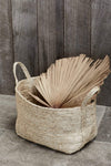 Small to medium natural jute basket with dried palm leaf